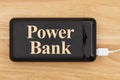 Portable power bank for charging USB devices on wood desk