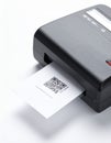 Portable Printer Printing a QR Code Label on White Background Royalty Free Stock Photo
