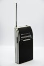 Portable radio receiver on a white background. Small player close-up. A battery-powered radio Royalty Free Stock Photo