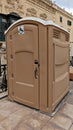 Portable restroom designed for disabled wheelchair accessibility placed near historic building with ornate architecture