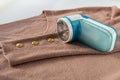 Portable shaver, trimmer, device for removing lint, fluff, pellets from clothes on a cashmere sweater. Clothing care