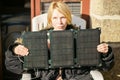Portable solar battery in the hands of a woman. Alternative energy source concept Royalty Free Stock Photo
