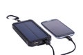 Portable solar charger for smart phone. Royalty Free Stock Photo