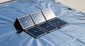 Portable solar panel array on reflective foil, renewable energy source Royalty Free Stock Photo