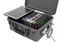 Portable solar powered battery pack with integrated components and cables in rugged case Royalty Free Stock Photo
