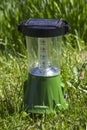 Portable solar powered flashlight in the garden in the sun charging Royalty Free Stock Photo