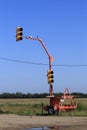 A portable stop Light on a road being worked on to direct traffic on a Highway out in the country
