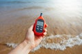 Portable thermometer in hand measuring outdoor air temperature and humidity Royalty Free Stock Photo