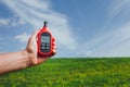 Portable thermometer in hand measuring outdoor air temperature and humidity Royalty Free Stock Photo