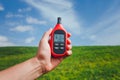 Portable thermometer in hand measuring outdoor air temperature and humidity Royalty Free Stock Photo