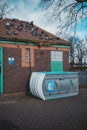 Portable Toilet laying on the side in the park