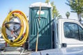 Portable toilet with pump loaded over small truck