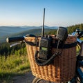 Portable two way radio communication device mounted securely on a wicker bicycle basket overlooking mountains Royalty Free Stock Photo
