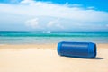 Portable wireless speakers on the beach.