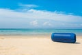 Portable wireless speakers on the beach.