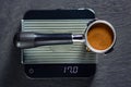 Portafilter on the scales with freshly ground morning coffee on