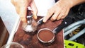 Portafilter and Tampering coffee in hand. Royalty Free Stock Photo