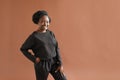 Portait of african american girl in black clothes smiling at camera