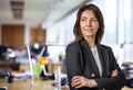 Mid aged businesswoman wearing business casual and standing at the office Royalty Free Stock Photo