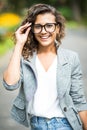 Portait of business woman in eyesglasses walking outdoor