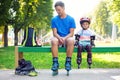 Portait of cute baby boy with inline skating instructor.