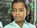 Portait of girl pupil looking serious in classroom