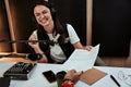 Portait of happy female radio host smiling, receiving a script paper from her male colleague while moderating a live Royalty Free Stock Photo