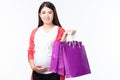 Portait happy young pregnant woman with shopping bags and touching her big belly isolated on white background. Pregnancy shopping