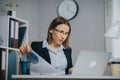 Portait of Pensive Business Lady Office Worker at Workplace. Confident Young Businesswoman Working With Data From