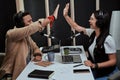 Portait of two cheerful radio hosts, young man and woman giving high five while talking, moderating a live show in Royalty Free Stock Photo