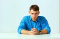 Portait of a young confident businessman sitting at the table