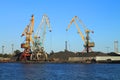 Portal cranes and mountains of crushed stone