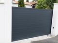 Portal dark grey steel closed metal gate gray of home suburb street access house