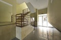 Portal of a house with polished granite floors, cream marble walls and red mental railings Royalty Free Stock Photo