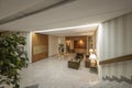 Portal of a residential house with granite stairs and floors, walls, office desk for the concierge, and papered and mirrored