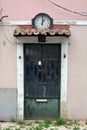 Portal. Streetphoto. Streets of Lisbon. Door and clock. Pink wall. Travel Portugal. Old Europe. Royalty Free Stock Photo