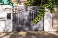 Portal of an urban single-family home with a metal fence with wrought iron work