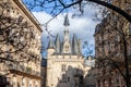 Porte Cailhau, a medieval gate, of the city center of Bordeaux, France, hidden behind branches.