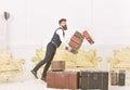 Porter, butler accidentally stumbled, dropping pile of vintage suitcases. Baggage insurance concept. Man with beard and