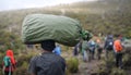 Porter Carrying Heavy Stuff On His Head, Climbing Mount Kilimanjaro, Mount Kilimanjaro National Park, Tanzania