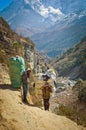 Porters carry heavy load in Himalaya, Nepal Royalty Free Stock Photo