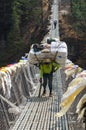 Porters carry heavy load in the Himalaya Royalty Free Stock Photo