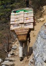 Porters carry heavy load in the Himalaya