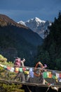 Porters carry heavy luggage on suspension bridge in Khumbu valley on a way to Everest Base camp Royalty Free Stock Photo