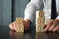 Portfolio diversification is shown on the photo using wooden cubes with signs of dollar