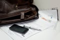 Portfolio with documents, pen and mobile phone Royalty Free Stock Photo