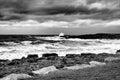 Porthcawl on a stormy day with waves crashing onto rocks, shot in monochrome, South Wales