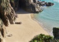 Porthcurno, Cornwall, UK - Top view of Pedn Vounder Beach with rocks and ocean on a sunny day