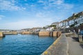 Porthleven harbour area and promenade wall on a warm October day