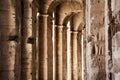 Portico with columns and buttresses in the side area of the large Roman amphitheater at El Jem